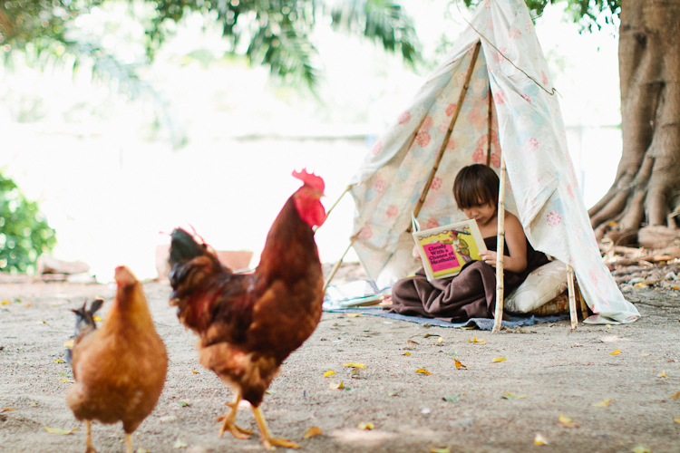 top five summer reads, summer reading, boy reading in a tent, reading in a tee-pee, reading in a tent, reading outside with chickens, reading outside in africa, reading outside